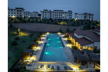 evening view of the swimming pool at Reveal Skyline apartments